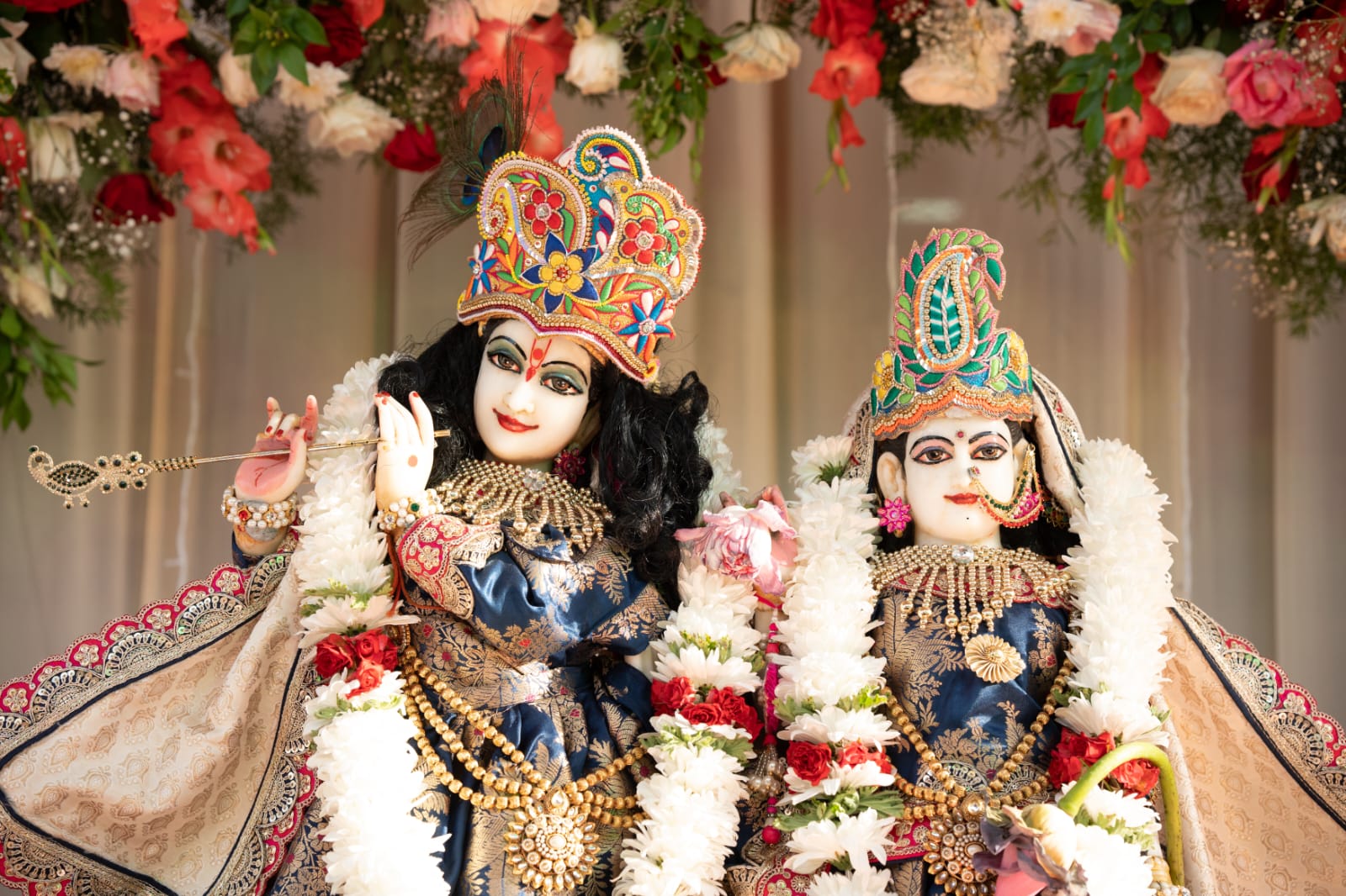 Sri Sri Radha Krishna deities adorned with flower garlands